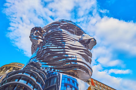 PRAGUE, CZECHIA - MARCH 7, 2022: The worms eye view of the moving statue of Franz Kafka's head by David Cerny, on March 7 in Pragueのeditorial素材