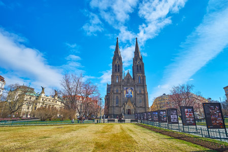 PRAGUE, CZECHIA - MARCH 7, 2022: The green lawn on Peace Square with St Ludmila Church in background, on March 7 in Pragueのeditorial素材