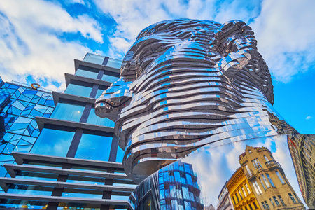 PRAGUE, CZECHIA - MARCH 7, 2022: The moving statue of Franz Kafka against the modern building of the shopping mall, on March 7 in Pragueのeditorial素材