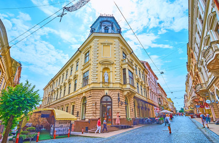 CHERNIVTSI, UKRAINE - JULY 16, 2021: The scenic mansions of Kobylyanska street in old town center with many popular restaurants, cafes and tourist stores, on July 16 in Chernivtsiのeditorial素材