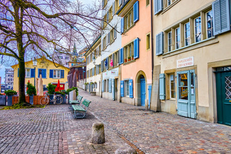 ZURICH, SWITZERLAND - APRIL 3, 2022: Walk on Schipfe embankment along medieval residential houses,...