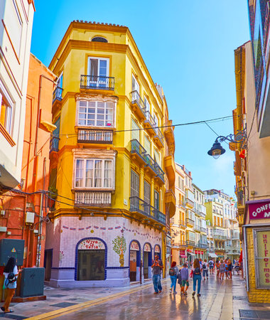 MALAGA, SPAIN - SEPT 28, 2019: The line of historic houses on the narrow Calle Cisneros street in old town, on Sept 28 in Malagaのeditorial素材