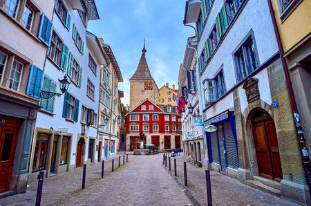 ZURICH, SWITZERLAND - APRIL 3, 2022: Historic Neumarkt with iconic Grimmenturm tower on background,...