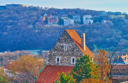 The stone building of Deli Rondella (Main Bastion) of Buda fortification against the backdrop of Nelson Mandela park on the slope of Gellert Hill, Taban, Budapest, Hungaryの写真素材