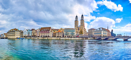 Panorama of the Limmat river with Munsterbrucke bridge and Grossmunster with houses on the river's bank, Zurich, Switzerlandの写真素材