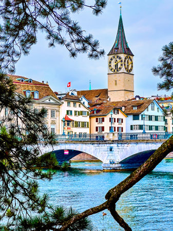 The stunning Peterskirche church framed by the pine tree branches offers a captivating view in Zurich, Switzerland.の写真素材