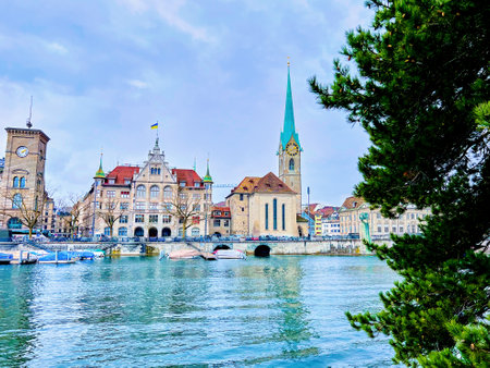 Fraumunster church seen through the pine tree branches presents a serene and enchanting view in Zurich, Switzerland.の写真素材