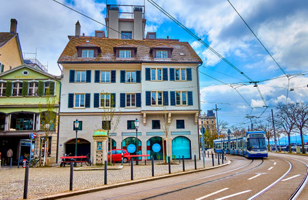 ZURICH, SWITZERLAND - APRIL 3, 2022: Modern tram rides along the Limmatquai embankment, passing by...