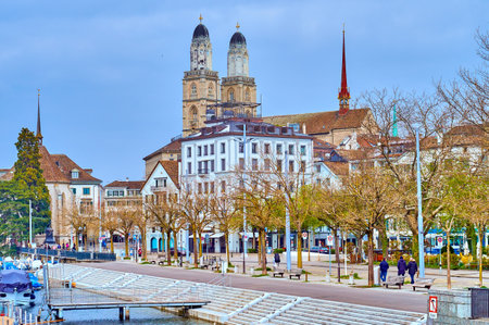 The iconic bell towers of Grossmunster church rise above the rooftops, defining the skyline of Zurich, Switzerland.の写真素材