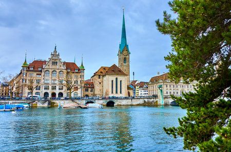 Fraumunster church seen through the pine tree branches presents a serene and enchanting view in Zurich, Switzerland.の写真素材