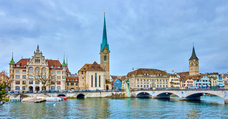 Panorama of the riverside housing of Limmat river with bell towers of Peterskirche and Fraumunster churches, Zurich, Switzerlandの写真素材