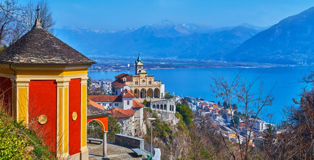 The vintage red Chapel of Resurrection in front of historic Madonna del Sasso Sanctuary against the Lake Maggiore, Orselina, Switzerlandの写真素材