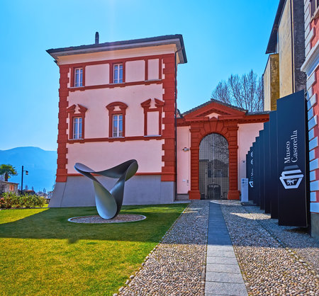 LOCARNO, SWITZERLAND - MARCH 26, 2022: The modern sculpture of Max Bill Garden in front of Museo Casorella facade, Locarno, Switzerlandのeditorial素材
