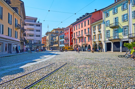 LOCARNO, SWITZERLAND - MARCH 26, 2022: Historic architecture and remains of the rails on Piazza Grande in Locarno city centre, Switzerlandのeditorial素材