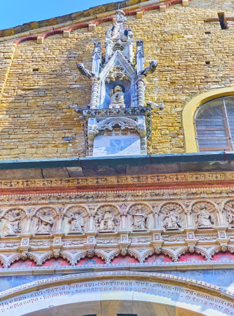 The sculptured Gothic aedicule with gargoyles above the Porta dei Leoni Bianchi (White Lions Gate) of Basilica, Santa Maria Maggiore, Bergamo, Italyの写真素材