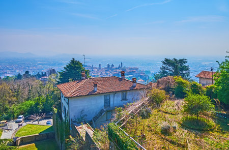 The silhouette of towers and roofs of Bergamo Alta (upper town) from the top of San Vigilio Castle, Bergamo, Italyの写真素材