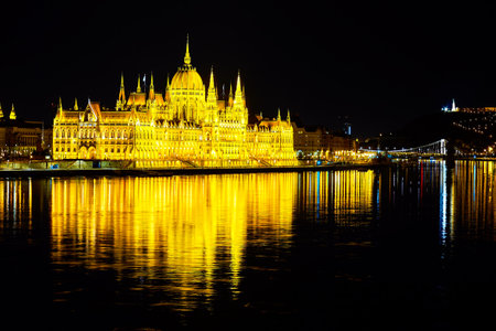 Bright illuminated Parliament building on bank of Danube River, Budapest, Hungaryの写真素材