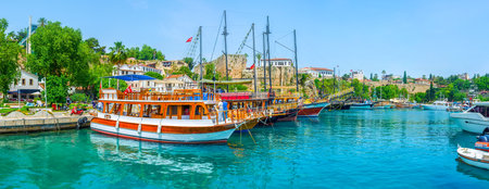 Panorama with wooden tourist ships in old Antalya port in Kaleici, Turkeyの写真素材