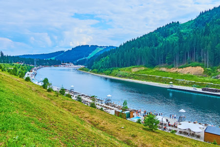 Enjoy the evening walk in park by the mountain Molodist Lake, Bukovel, Carpathians, Ukraine