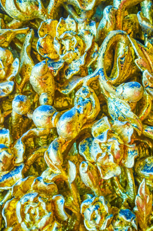 The golden carved decoration elements in Ordination Hall of Wat Suthat Temple in Bangkok, Thailandの写真素材