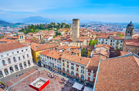 Historic Piazza Vecchia with old townhouses, Palazzo Nuovo from the tower of Palazzo della Podesta, observing mountain landscape, Citta Alta housing and Torre del Gombito of Bergamo, Italyの写真素材