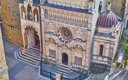 The sculptured marble Capella Colleoni and Red Lion Gate (Porta dei Leoni Rossi) of Santa Maria Maggiore Basilica on Piazza Duomo, Bergamo, Italyの写真素材