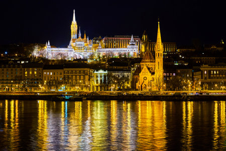 The view through Danube river on bright Fisherman's Bastion at night, Budapest, Hungaryの写真素材