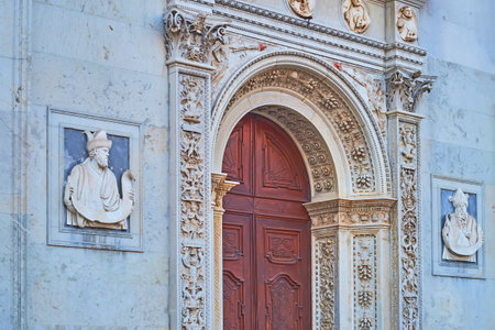 The sculptured facade details of historic San Lorenzo Cathedral in Lugano, Ticino, Switzerlandの写真素材