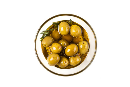 Olives and olive oil in glass bowl with rosemary isplated on whiteの写真素材