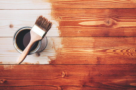 Varnishing a wooden shelf using paintbrushの写真素材