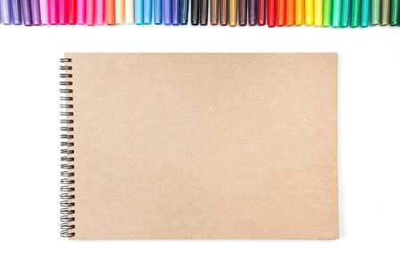 Row of colored felt tip pens isolated on white with notebookの写真素材