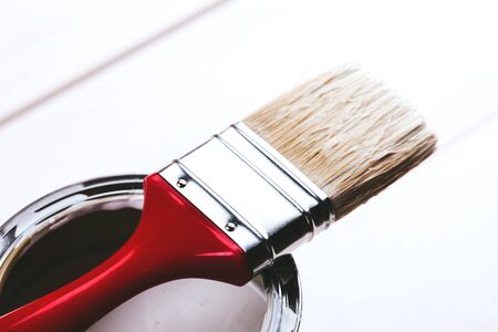 Varnishing and painting a wooden shelf using paintbrushの写真素材