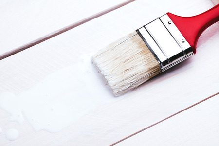 Varnishing and painting a wooden shelf using paintbrushの写真素材