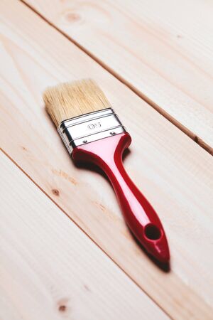 paintbrush lying on wooden surface of tableの写真素材