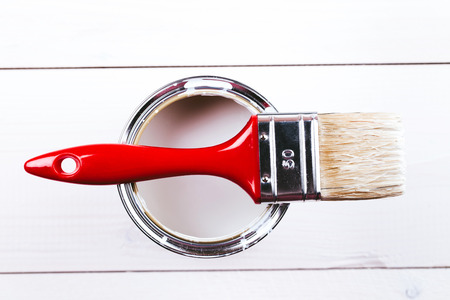 Varnishing and painting a wooden shelf using paintbrushの写真素材