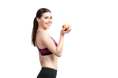 Sport happy girl with apple isolated on whiteの写真素材