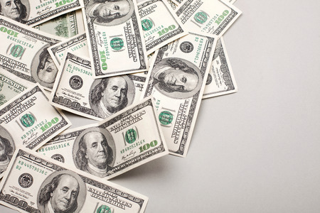 money american hundred dollar bills - horizontal on grey background money american hundred dollar bills - horizontal on grey background