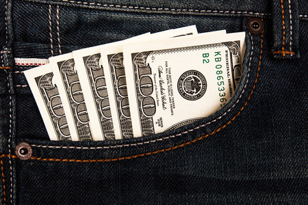 Dollars bank notes lying in jeans pocketの写真素材