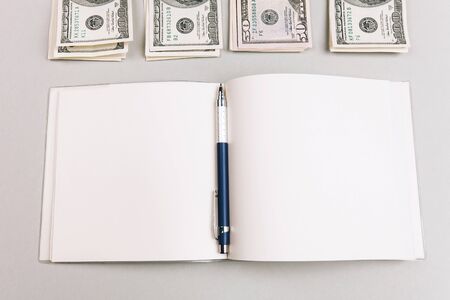 savings, finances, economy and concept - close up of man counting money and making notesの写真素材