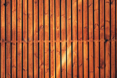Background of wooden fence with smooth brown planksの写真素材