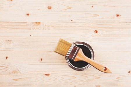 Copyspace with paint brush on can lying on wooden clean table. Top view. Copyspace.の写真素材