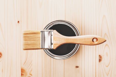 Copyspace with paint brush on can lying on wooden clean table. Top view. Copyspace.の写真素材