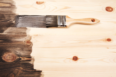Grey color painting on wooden table or fence or wall, or flour, use for home decorated. House renovation. Half - painted surface. Smear of paint brush.の写真素材