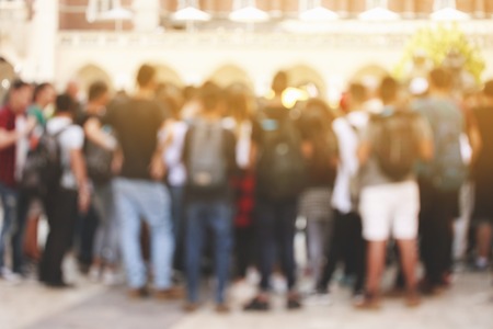 Blurred group of unrecognizable tourists in the city.の写真素材
