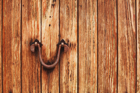 Old wooden door with bright texture on Mallorca, Spain. Metal hand, old knocker.の写真素材