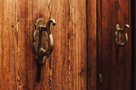 Old wooden door with bright texture on Mallorca, Spain. Metal hand, old knocker.の写真素材