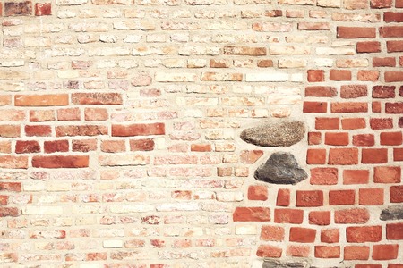 Destroyed and renovated brick wall texture. Different types of bricks forming grunge texture. Can be also used like background.の写真素材