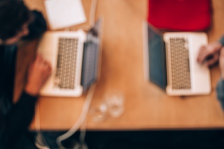 Blurred background of coworkers with customized workspace are working with a laptops.の写真素材