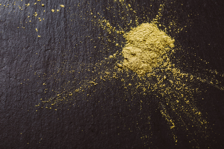 Powdered matcha green tea on black stone surface. Traditional Japanese and tea matchaの写真素材