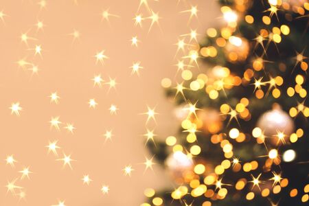 Blurred festive background made with christmas tree and lights. New year backdrop.の写真素材